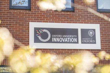 Oxford University Innovation sign mounted on the exterior wall of the building