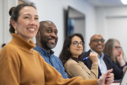 A diverse group of men and women engaged in a meeting 