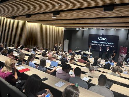 A student team pitching their venture to an audience in a lecture theatre