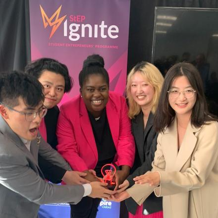 Image showing students linking hands in front of a Step Ignite banner