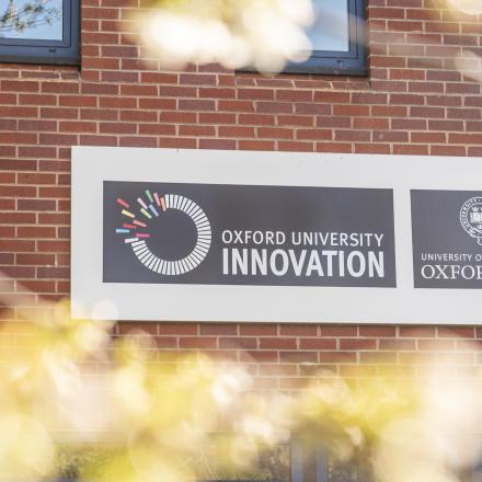 Oxford University Innovation sign mounted on the exterior wall of the building