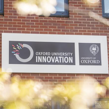 Oxford University Innovation sign mounted on the exterior wall of the building