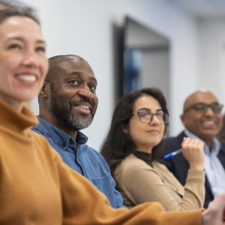 A diverse group of men and women engaged in a meeting 