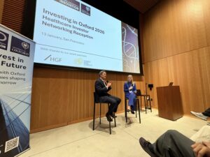 Two speakers take part in a fireside chat on stage at the Investing in Oxford 2026 healthcare investor event in San Francisco, with Oxford University Innovation branding displayed behind them.
